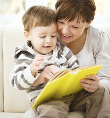 Mother is reading book for her son
