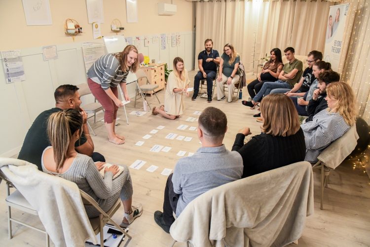 A group of expectant parents sitting in a circle at an antenatal class